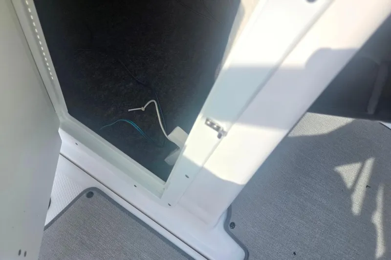 Slide: The Image of 2022 Yamaha AR210 boat interior showing open compartment with visible wiring. - 15