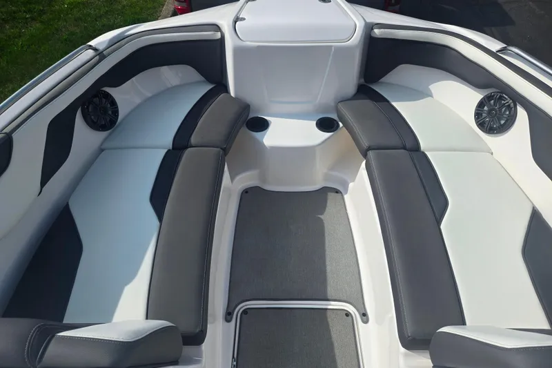 Slide: The Image of 2022 Yamaha Boats AR210 interior with sleek seating and integrated speakers. - 17