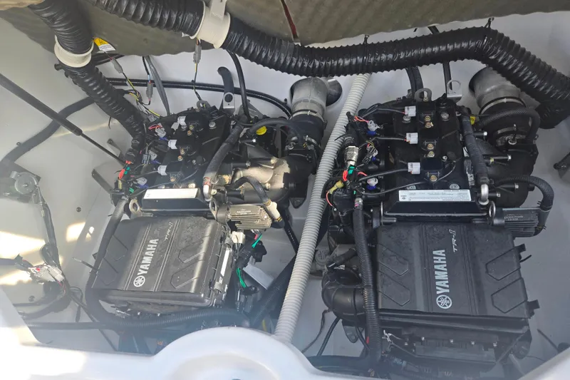 Slide: The Image of Twin engines of a 2022 Yamaha Boats AR210, showcasing intricate wiring and components. - 24
