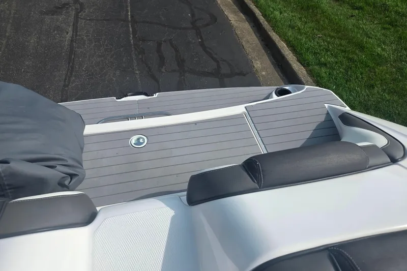 Slide: The Image of 2022 Yamaha AR210 boat deck with cushioned seating and sleek design. - 25