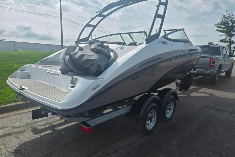 Slide: The Image of 2022 Yamaha Boats AR210 on trailer, parked outdoors, rear view. - 3