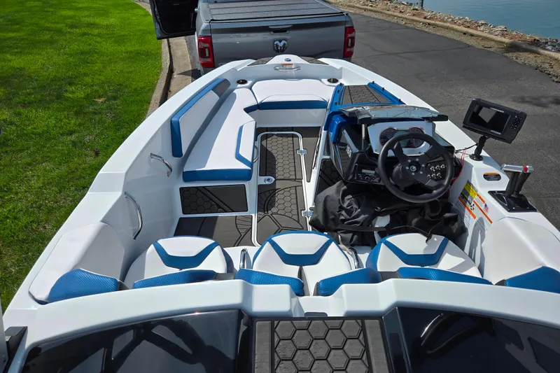 Slide: The Image of 2021 Scarab 165 ID boat interior with blue seating and modern dashboard controls. - 10