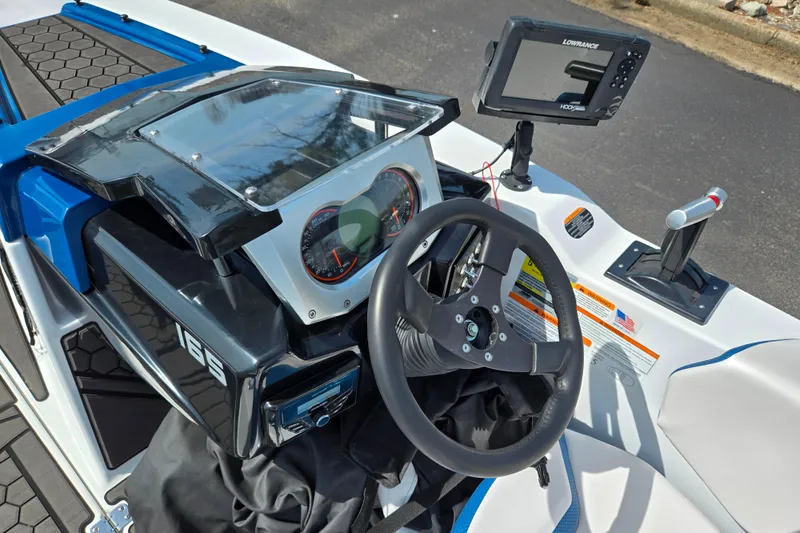 Slide: The Image of 2021 Scarab 165 ID boat dashboard with steering wheel and navigation system. - 11