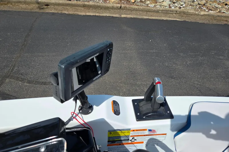 Slide: The Image of Control panel of 2021 Scarab 165 ID boat with navigation display and throttle lever. - 12