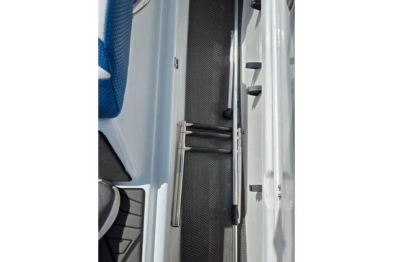 Slide: The Image of Interior view of a 2021 Scarab 165 ID boat, featuring seating and storage area. - 14
