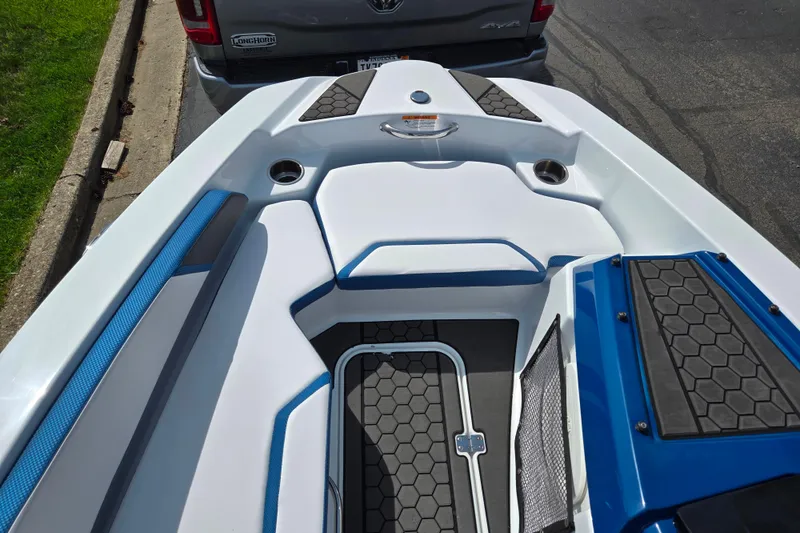 Slide: The Image of 2021 Scarab 165 ID boat interior with blue and white seating and hexagonal flooring. - 15