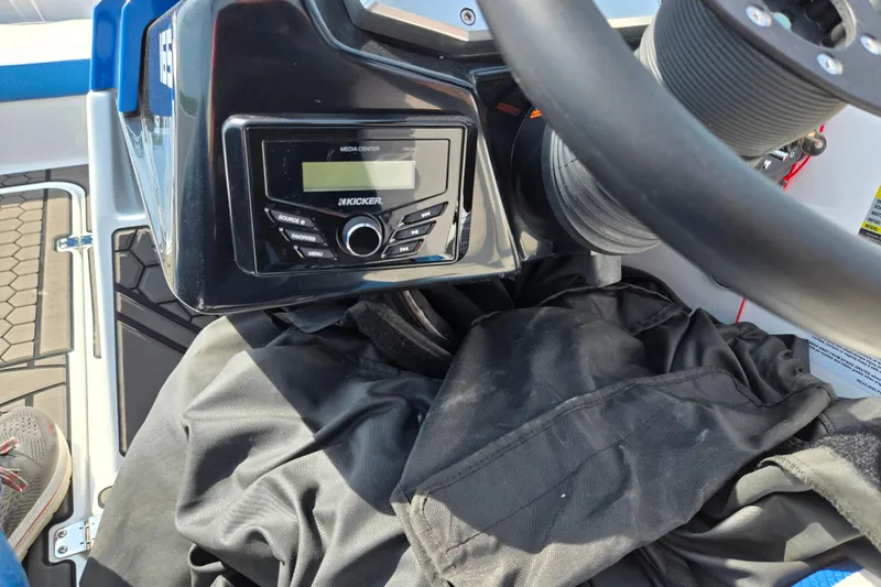 Slide: The Image of Dashboard of a 2021 Scarab 165 ID boat featuring a Kicker media center. - 16