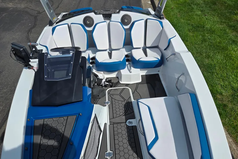 Slide: The Image of 2021 Scarab 165 ID boat interior with blue and white seating, modern dashboard, and sleek design. - 18