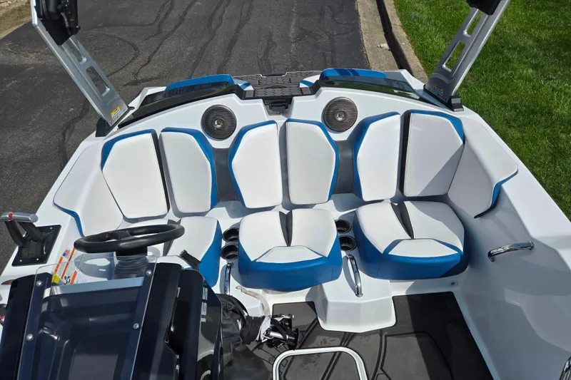 Slide: The Image of 2021 Scarab 165 ID boat interior with blue and white seating and steering wheel. - 19