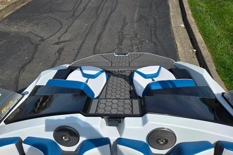 Slide: The Image of 2021 Scarab 165 ID boat interior with blue and white seating, hexagonal pattern flooring. - 20