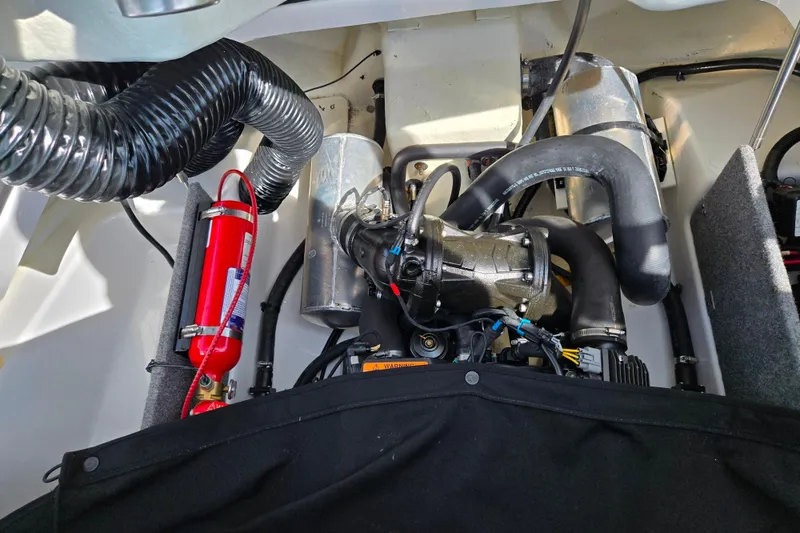 Slide: The Image of Engine compartment of a 2021 Scarab 165 ID boat with visible components and fire extinguisher. - 21