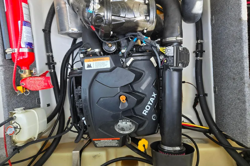 Slide: The Image of Engine compartment of a 2021 Scarab 165 ID boat with Rotax engine and safety equipment. - 22