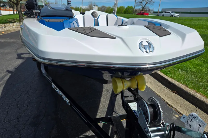 Slide: The Image of 2021 Scarab 165 ID boat on trailer, white hull, parked outdoors. - 6