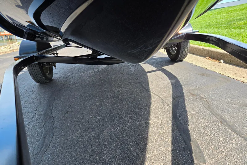 Slide: The Image of Underneath view of a 2021 Scarab 165 ID boat on a trailer. - 7