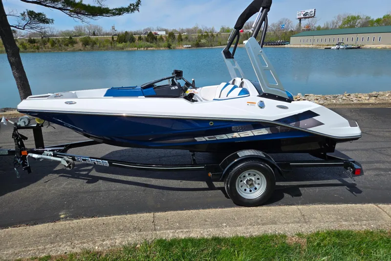 Slide: The Image of 2021 Scarab 165 ID boat on trailer by a lake, showcasing sleek design. - 9