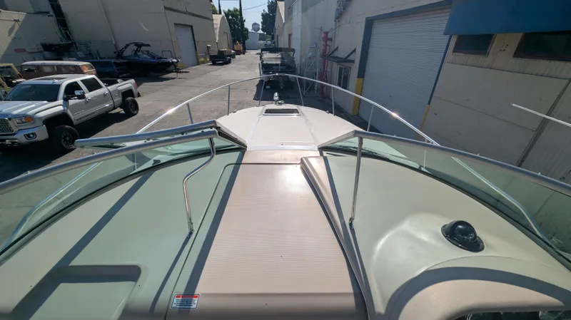 Slide: The Image of 2004 Sea Ray 280 Sundancer boat docked in a marina, view from the bow. - 10