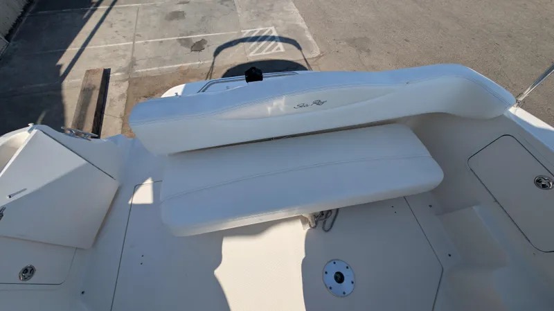 Slide: The Image of 2004 Sea Ray 280 Sundancer boat interior with white seating and deck view. - 13