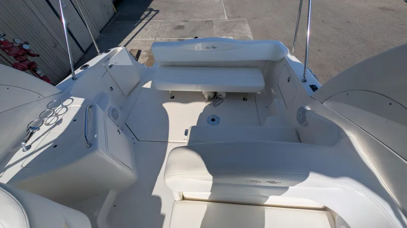 Slide: The Image of 2004 Sea Ray 280 Sundancer boat interior with seating and cup holders. - 15