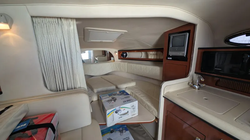 Slide: The Image of Interior of 2004 Sea Ray 280 Sundancer yacht with cozy seating and modern amenities. - 19