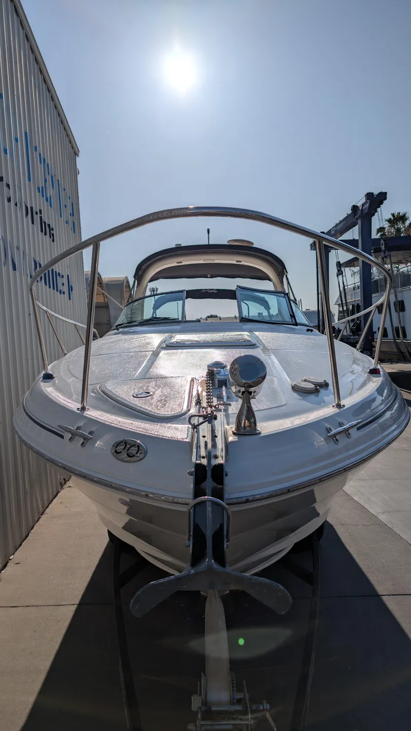 Slide: The Image of 2004 Sea Ray 280 Sundancer boat docked under bright sun. - 2