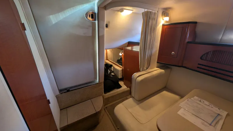 Slide: The Image of Interior of 2004 Sea Ray 280 Sundancer, featuring seating and cabin amenities. - 22