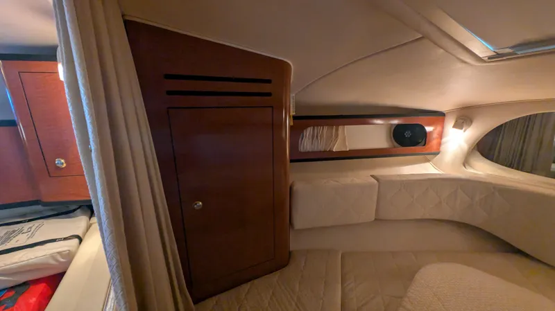 Slide: The Image of Interior cabin of 2004 Sea Ray 280 Sundancer, featuring cozy seating and wooden cabinetry. - 25
