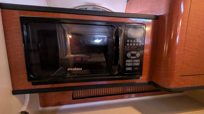 Slide: The Image of Microwave in 2004 Sea Ray 280 Sundancer boat interior kitchen area. - 29