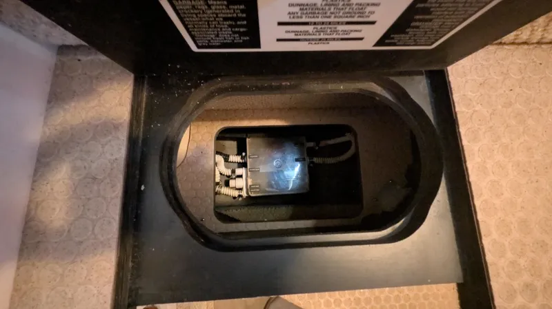 Slide: The Image of Electrical compartment inside a 2004 Sea Ray 280 Sundancer boat, featuring wiring and components. - 30