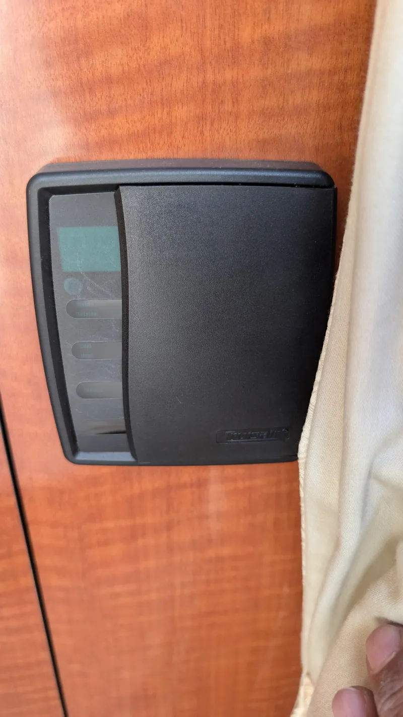 Slide: The Image of Control panel on 2004 Sea Ray 280 Sundancer boat, mounted on wooden surface. - 35