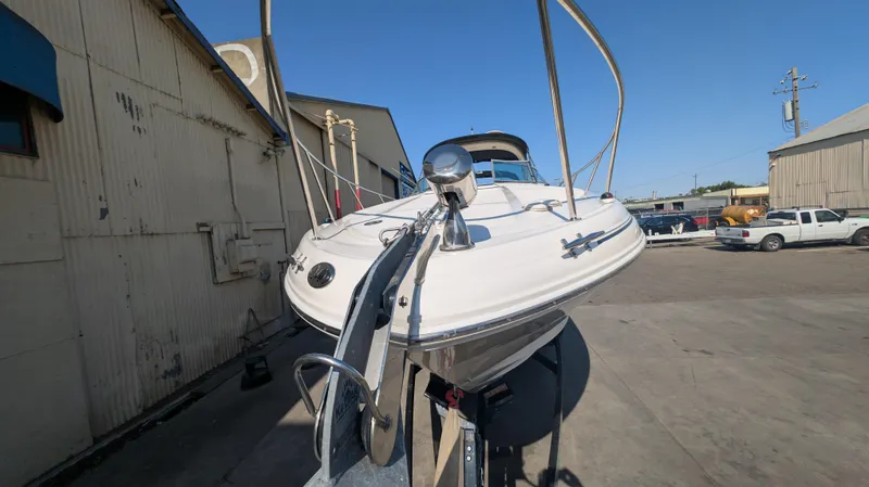 Slide: The Image of 2004 Sea Ray 280 Sundancer boat on trailer in industrial area. - 5