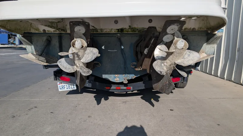 Slide: The Image of Rear view of 2004 Sea Ray 280 Sundancer boat with dual propellers on a trailer. - 6