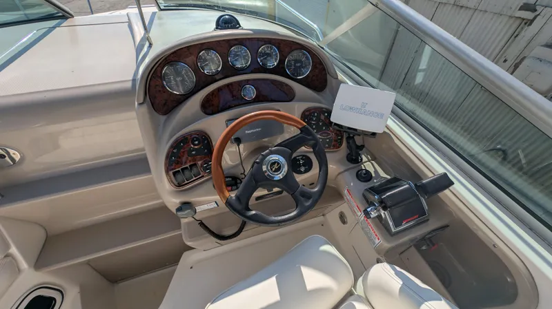 Slide: The Image of 2004 Sea Ray 280 Sundancer cockpit with steering wheel and control panel. - 8