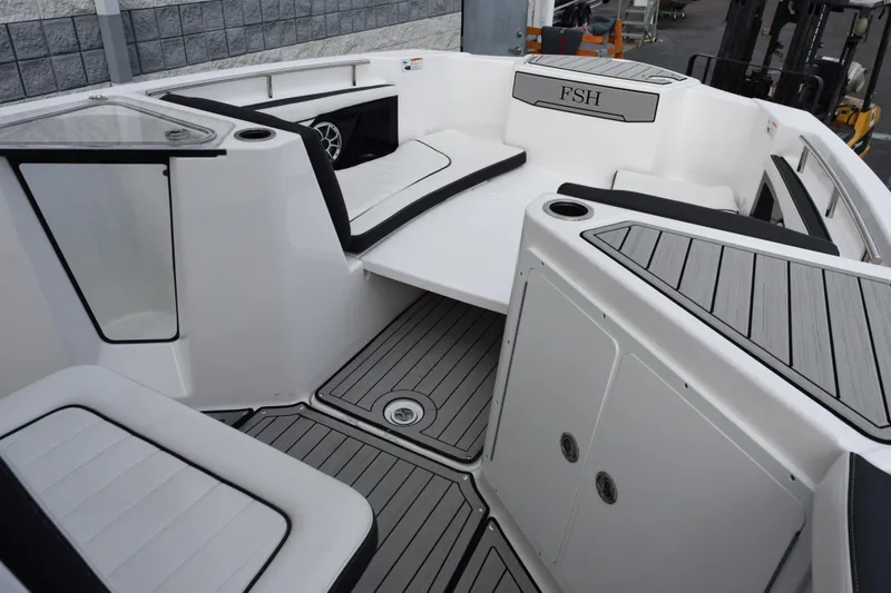 Slide: The Image of 2021 Yamaha Boats 255 FSH Sport E interior with sleek seating and modern design. - 11