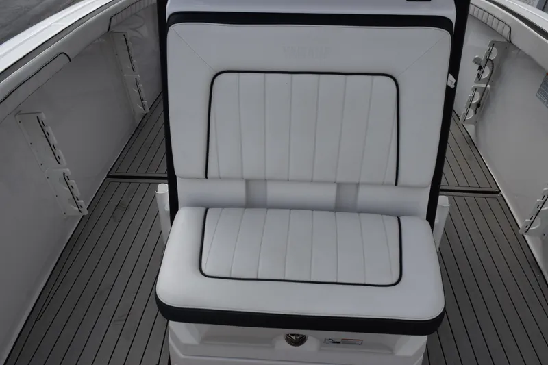 Slide: The Image of White cushioned seat on 2021 Yamaha Boats 255 FSH Sport E, featuring sleek design. - 12
