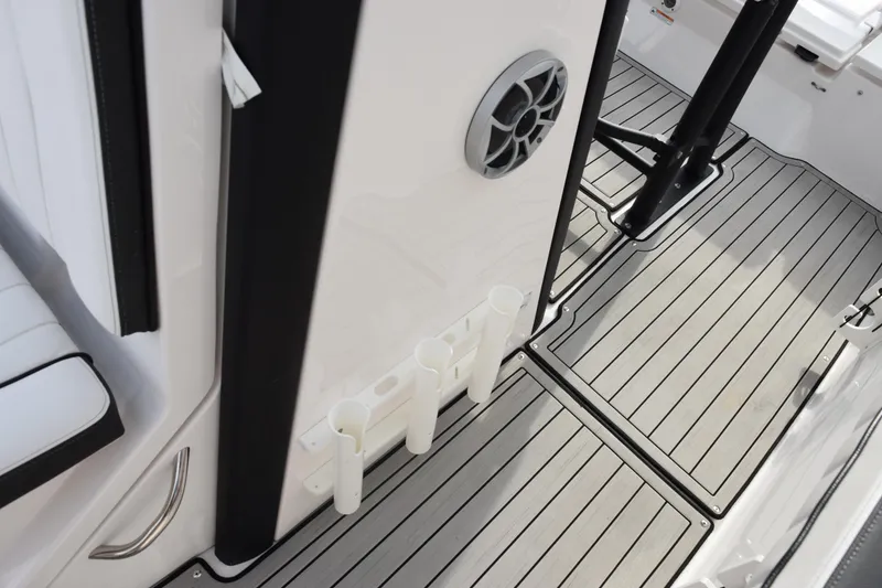 Slide: The Image of 2021 Yamaha Boats 255 FSH Sport E interior with rod holders and speaker. - 14