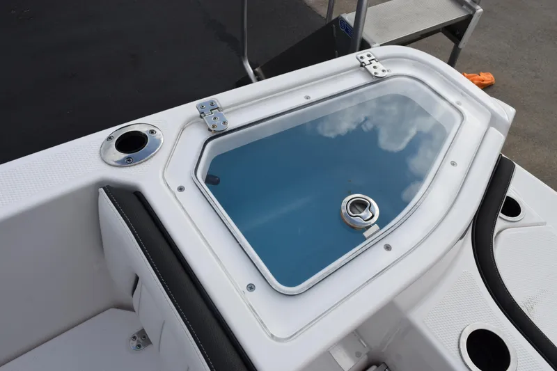 Slide: The Image of 2021 Yamaha Boats 255 FSH Sport E livewell with clear lid and rod holders. - 19