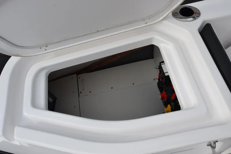 Slide: The Image of Open storage compartment on a 2021 Yamaha Boats 255 FSH Sport E. - 21