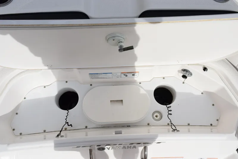 Slide: The Image of 2021 Yamaha Boats 255 FSH Sport E storage compartment with open hatch. - 22