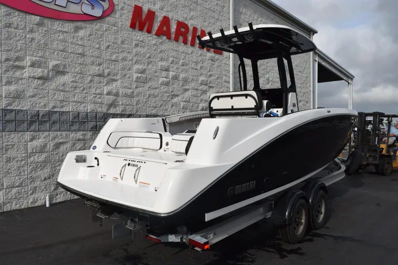 Slide: The Image of 2021 Yamaha Boats 255 FSH Sport E on trailer, parked outside marine dealership. - 4