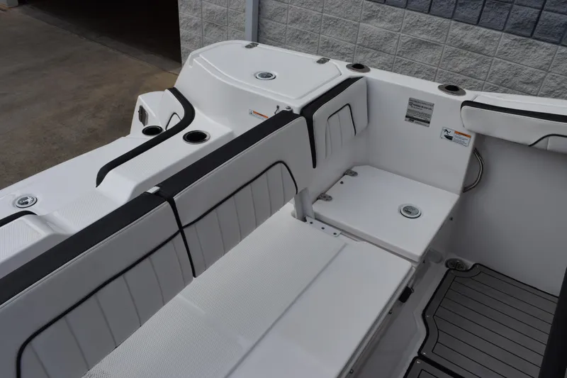 Slide: The Image of 2021 Yamaha Boats 255 FSH Sport E interior seating with sleek design and cup holders. - 8