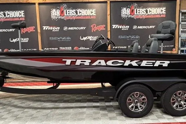 The Image of 2026 Tracker Savage 215 boat displayed at Angler's Choice event with branded backdrop. - 1