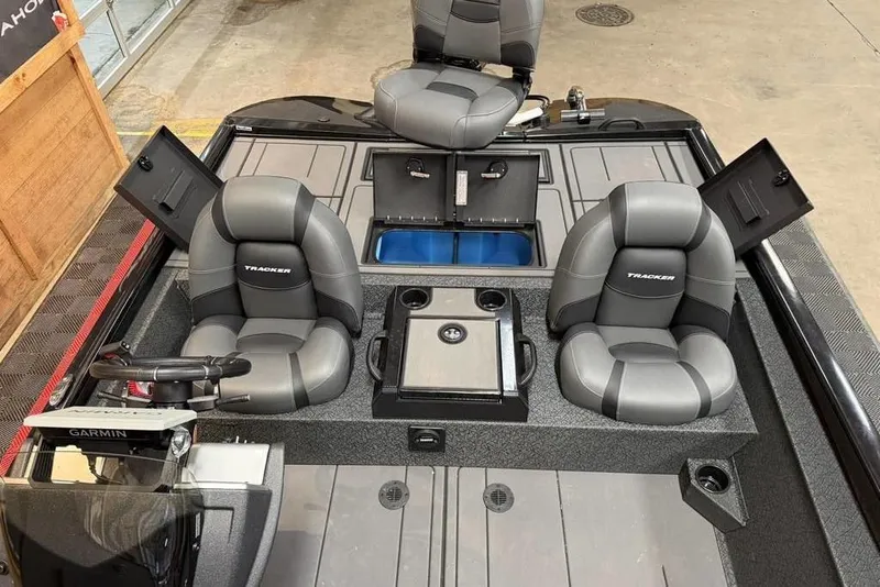 Slide: The Image of 2026 Tracker Savage 215 boat interior with gray seating and storage compartments. - 11