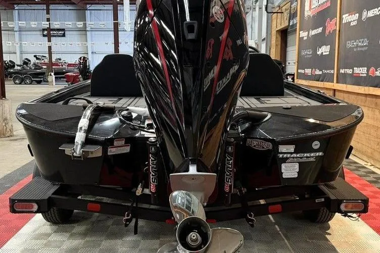 Slide: The Image of 2026 Tracker Savage 215 boat on trailer, rear view in showroom setting. - 3