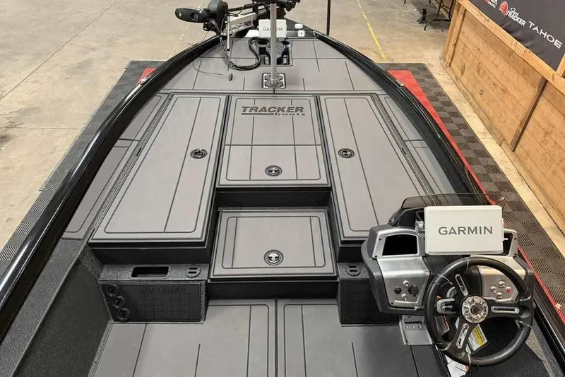 Slide: The Image of 2026 Tracker Savage 215 boat interior with Garmin navigation system and sleek design. - 4