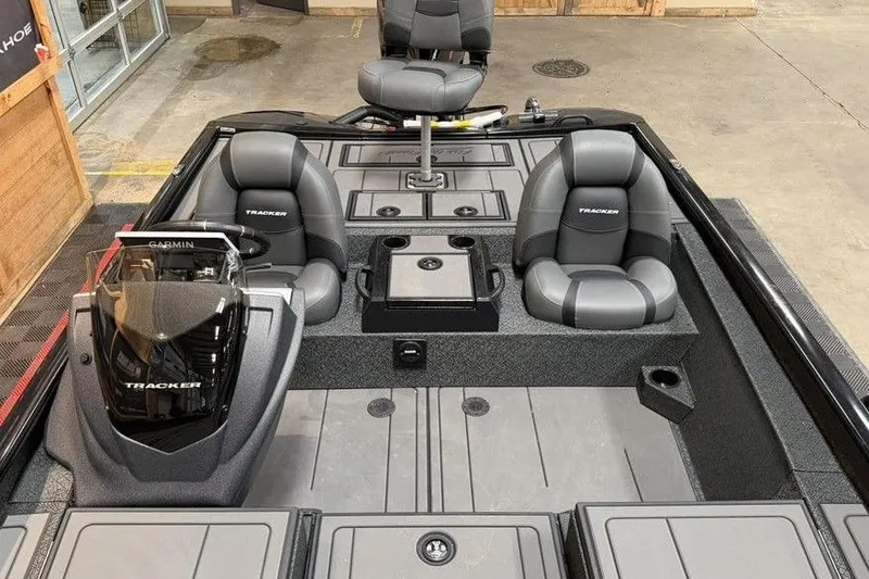 Slide: The Image of 2026 Tracker Savage 215 boat interior with seating and Garmin equipment. - 6