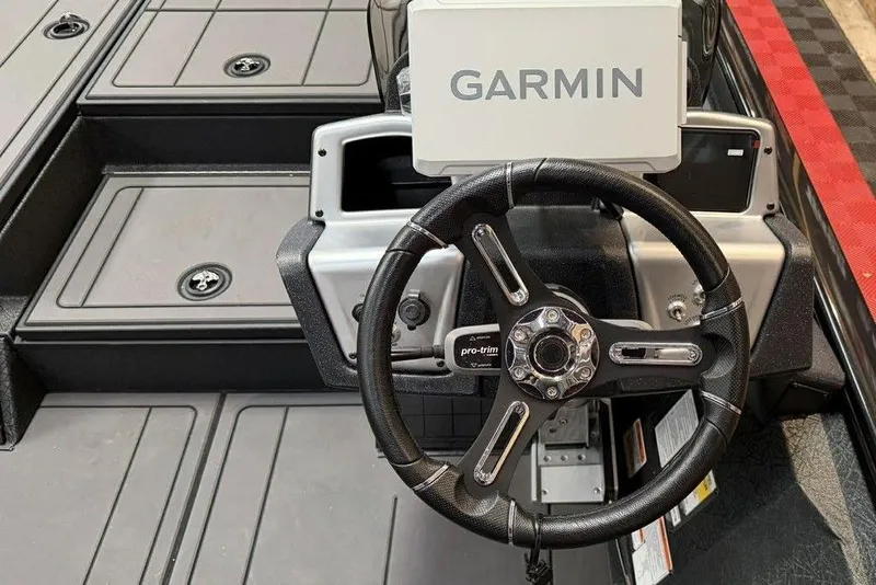 Slide: The Image of Steering wheel and Garmin display on 2026 Tracker Savage 215 boat. - 7