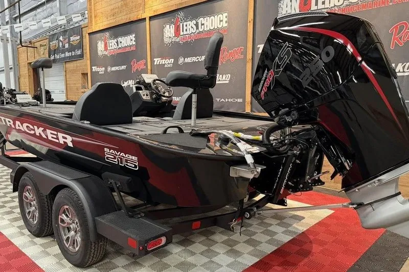 Slide: The Image of 2026 Tracker Savage 215 boat on display with powerful engine and sleek design. - 8