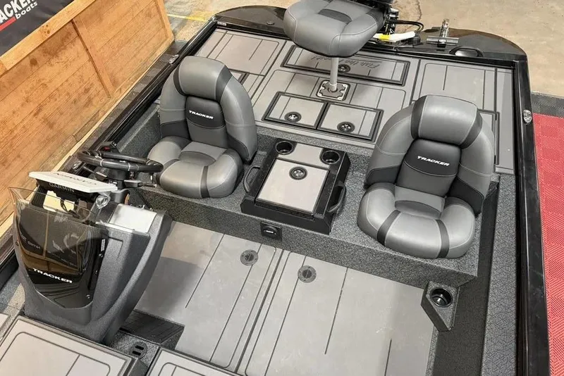 Slide: The Image of 2026 Tracker Savage 215 boat interior with gray seating and modern dashboard. - 9