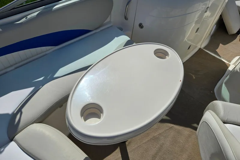 Slide: The Image of 2006 Glastron DX 235 boat interior with oval table and seating. - 13