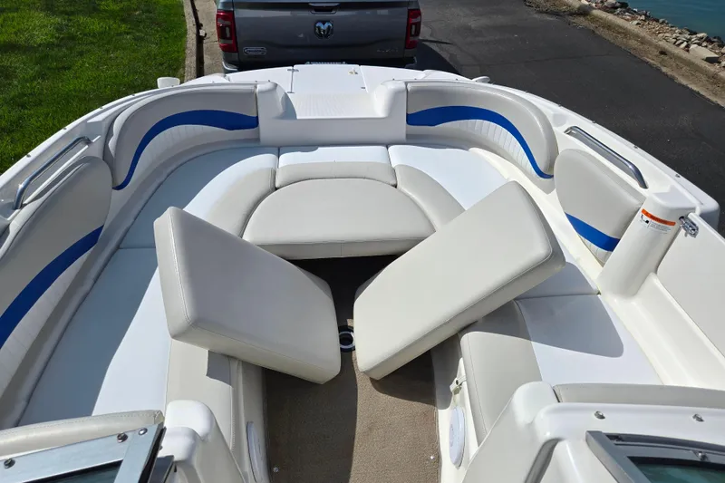 Slide: The Image of 2006 Glastron DX 235 boat interior with white and blue seating arrangement. - 18